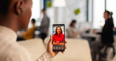 a black man holding a phone and having a video call