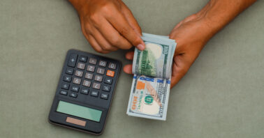 a man calculating and counting money
