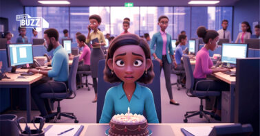 a sad looking lady sitting alone at her office desk with cake in front of her with people walking in the background