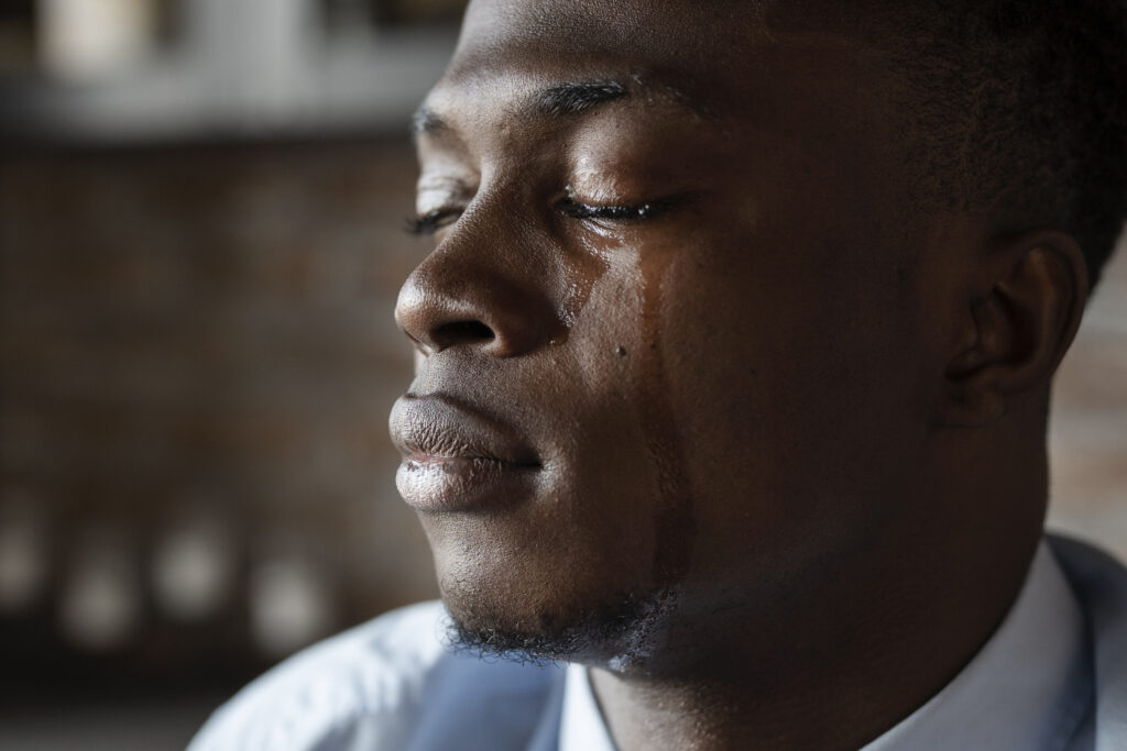 a sad looking man crying