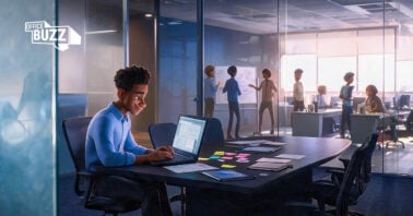 An employee working focused on a laptop in a quiet office space with headphones, representing deep focus and productivity.
