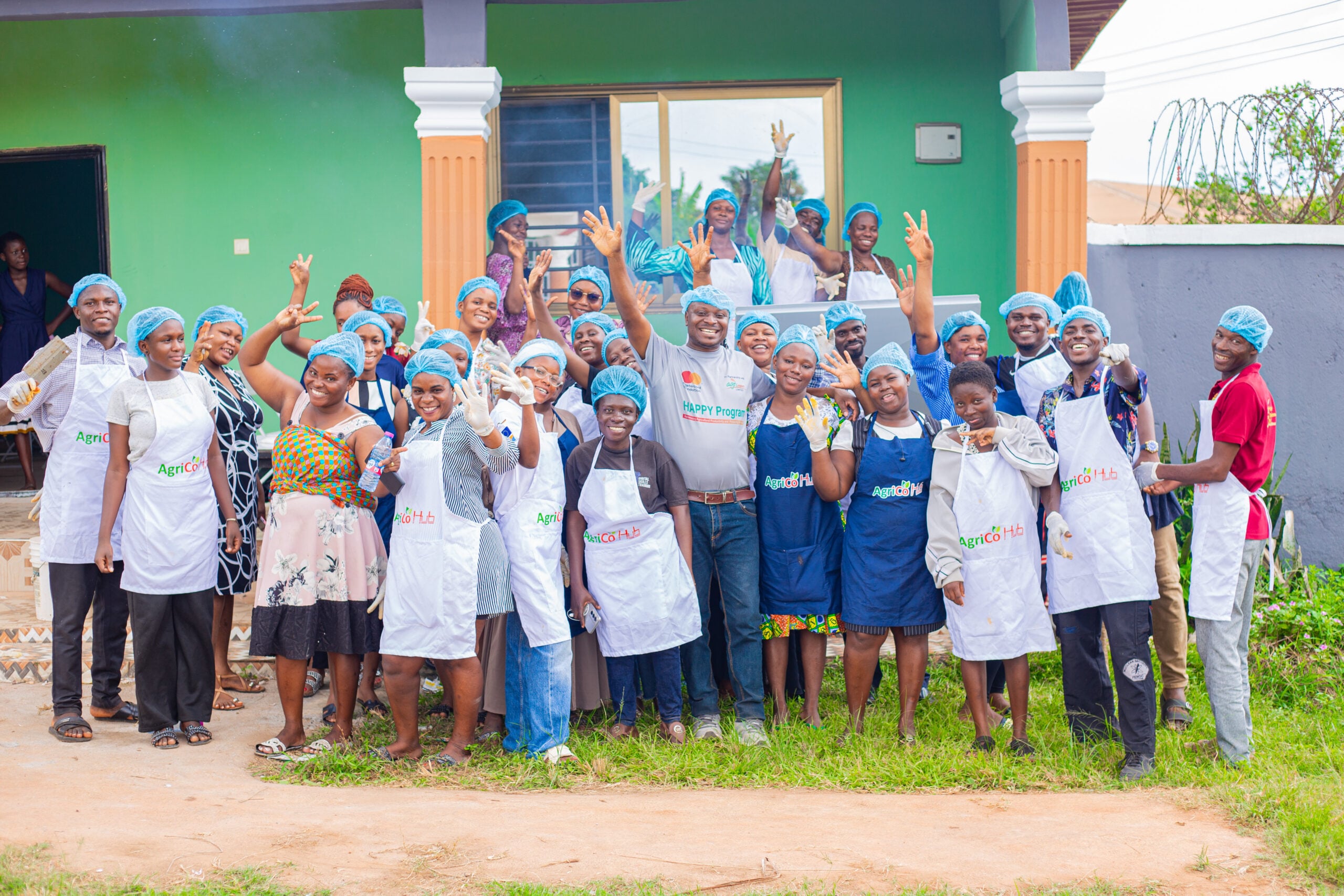 Group of young Grill & Grow training participants celebrating together in white aprons and chef hats in Bono East Region under the Grill and Grow initiative by Jobberman Ghana
